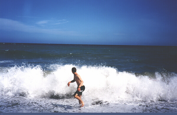 [Blake runs from a wave]